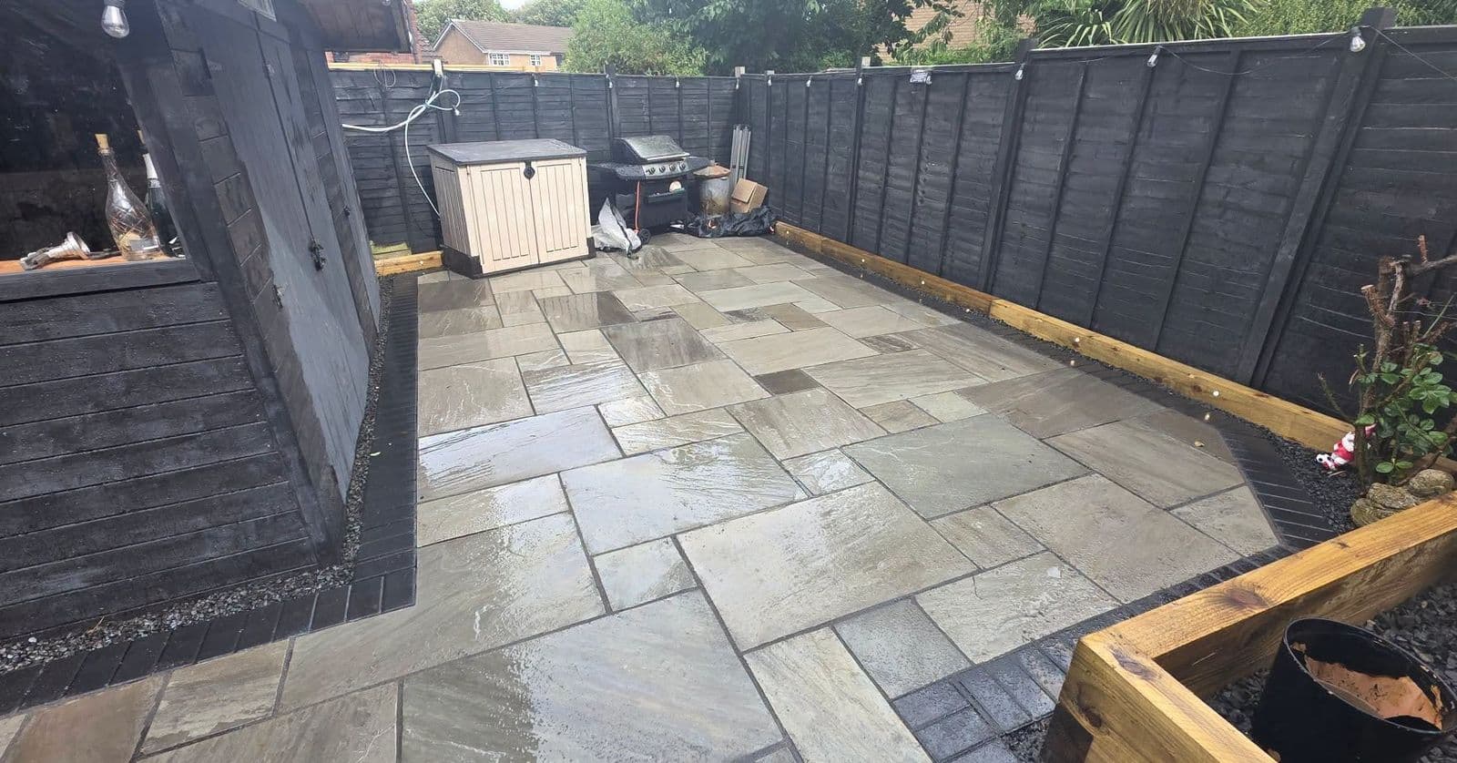 Grey sandstone patio and sleeper planters in Gateshead