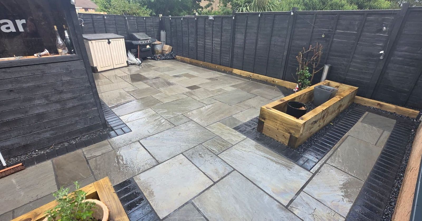Grey sandstone patio and sleeper planters in Gateshead, photo 2 of 10