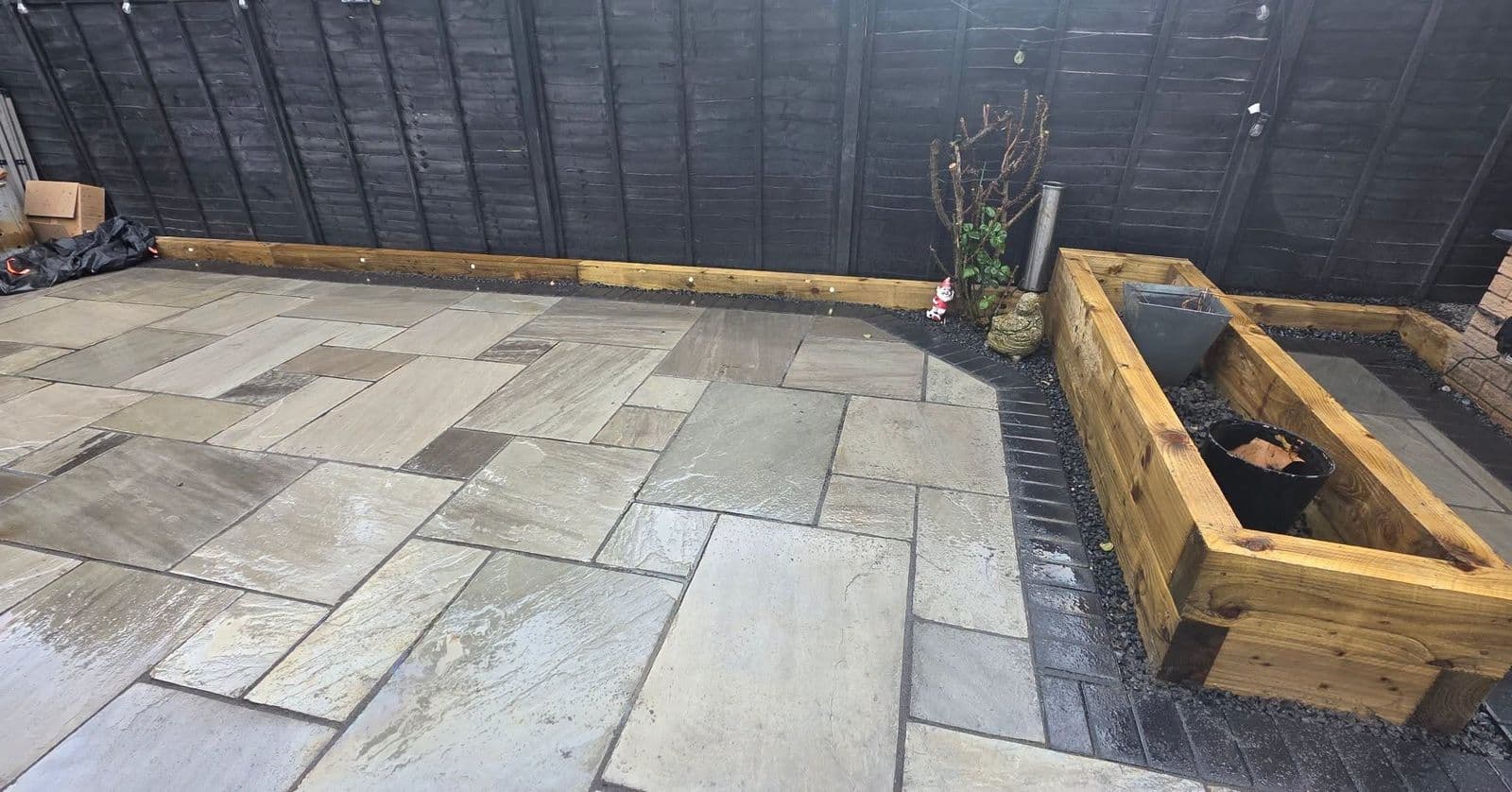 Grey sandstone patio and sleeper planters in Gateshead, photo 3 of 10