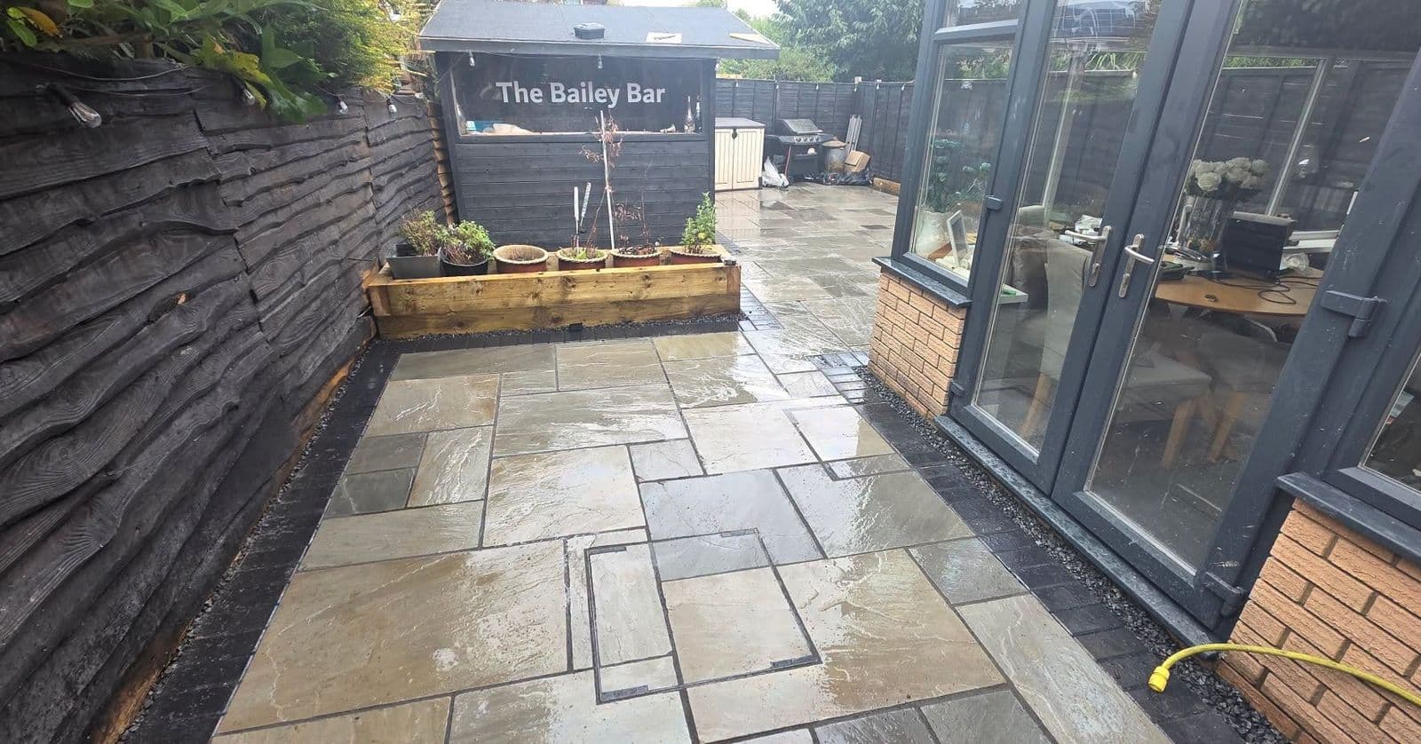 Grey sandstone patio and sleeper planters in Gateshead, photo 7 of 10
