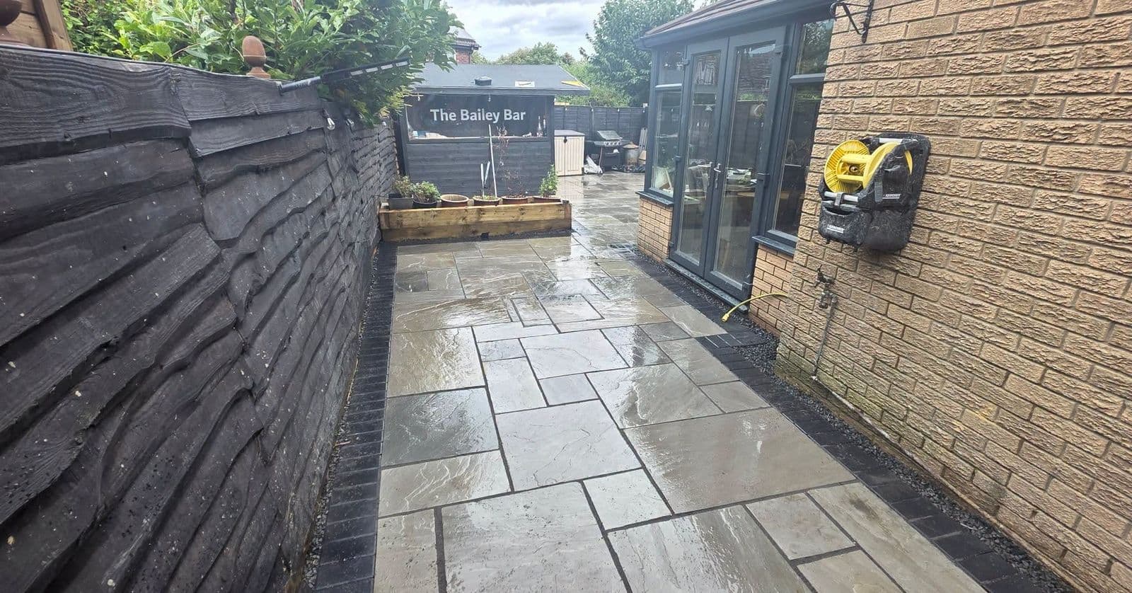 Grey sandstone patio and sleeper planters in Gateshead, photo 8 of 10