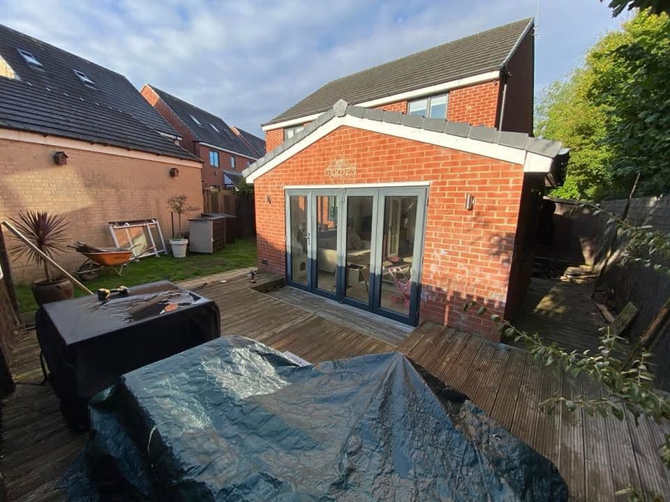 Rotten decking replaced with sandstone and artificial grass in Hebburn, photo 2 of 18