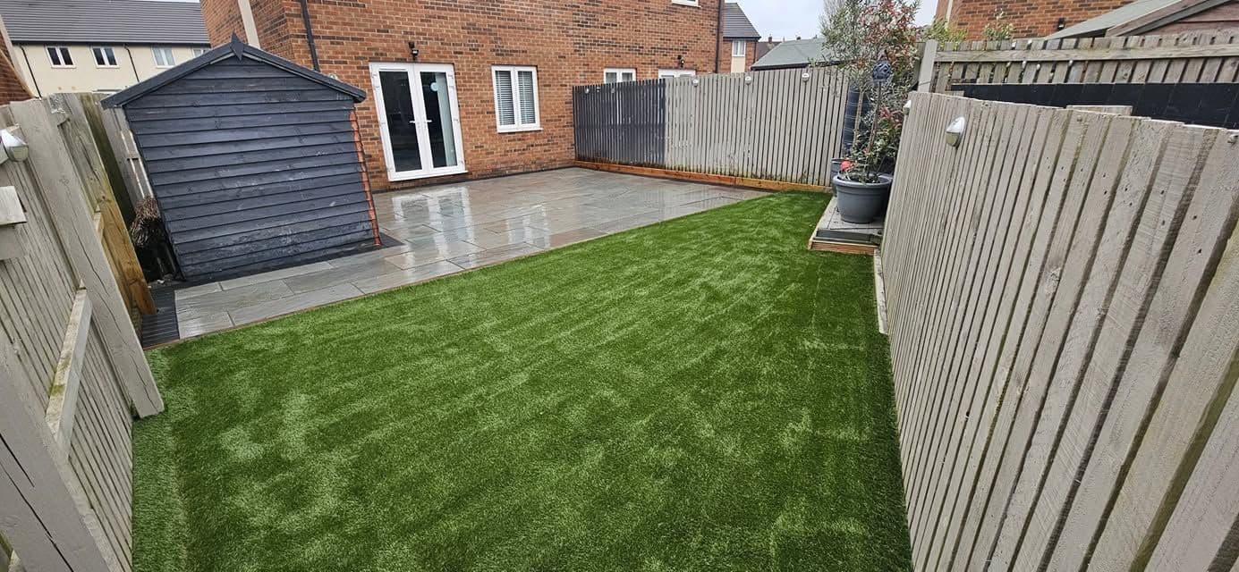After: Grey sandstone patio and artificial grass in Jarrow