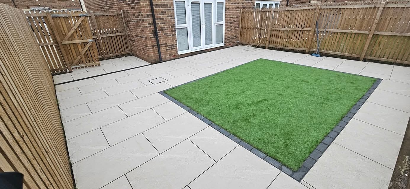 After: White porcelain patio framing an artificial lawn