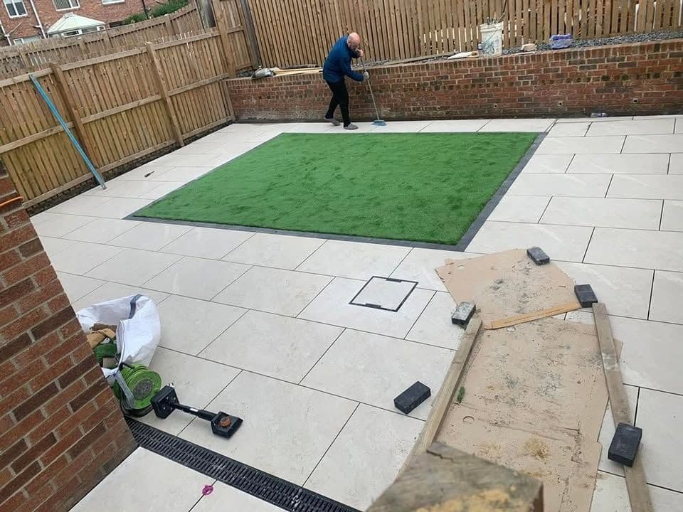 White porcelain patio framing an artificial lawn, photo 5 of 21