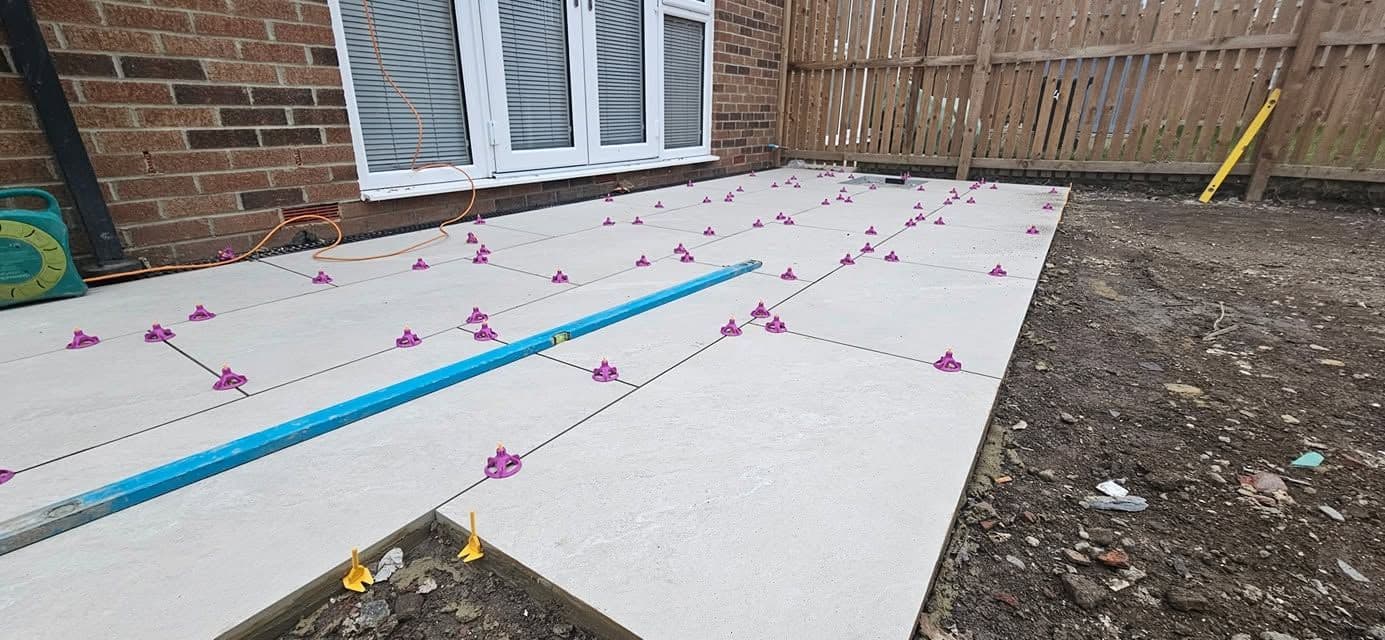 White porcelain patio framing an artificial lawn, photo 7 of 21