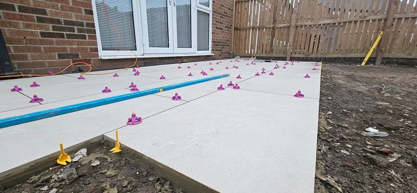 White porcelain patio framing an artificial lawn, photo 8 of 21