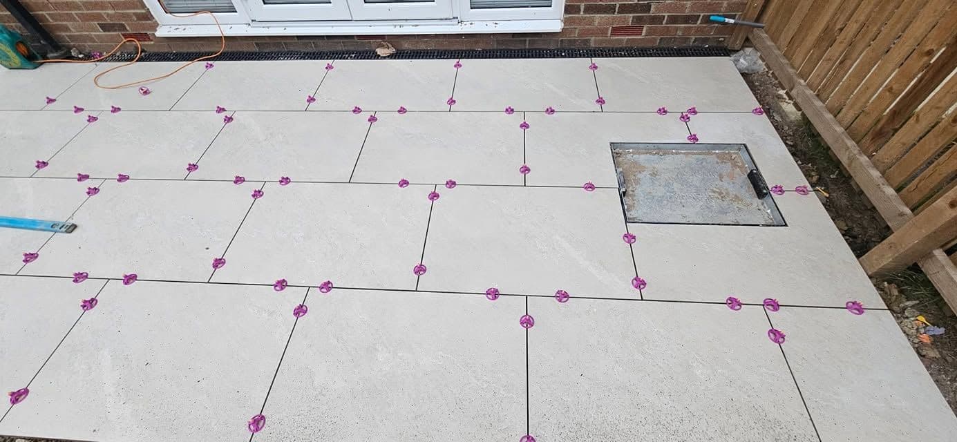 White porcelain patio framing an artificial lawn, photo 10 of 21