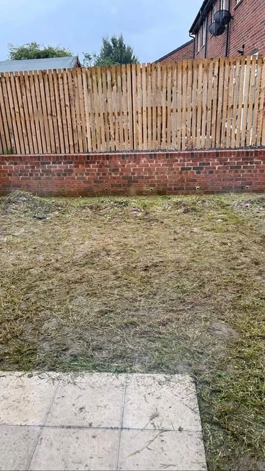 Before: White porcelain patio framing an artificial lawn